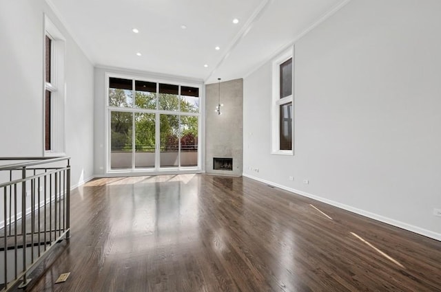 1018 N Honore Ave Unit C, Chicago, IL 60622 - unfurnished living room featuring wood finished floors, a high end fireplace, recessed lighting, baseboards, and crown molding