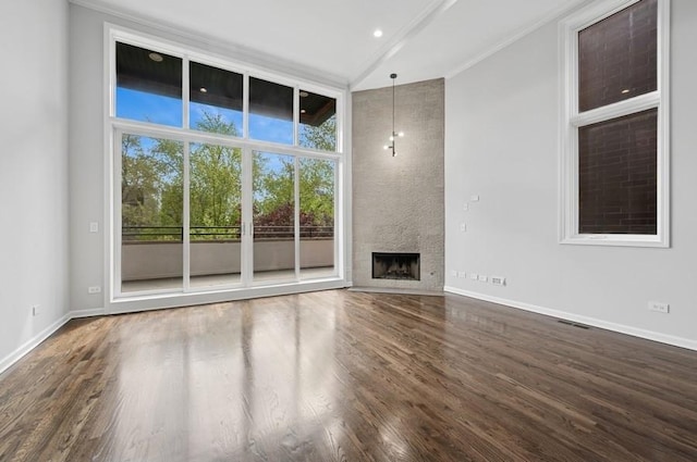 1018 N Honore Ave Unit C, Chicago, IL 60622 - unfurnished living room with dark wood finished floors, baseboards, a fireplace, recessed lighting, and crown molding