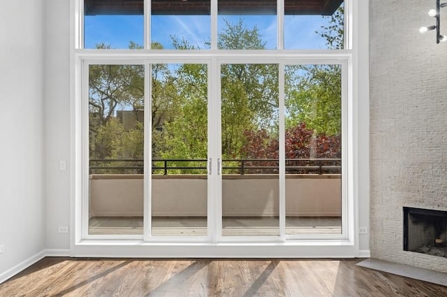 1018 N Honore Ave Unit C, Chicago, IL 60622 - doorway to outside with a stone fireplace and wood finished floors