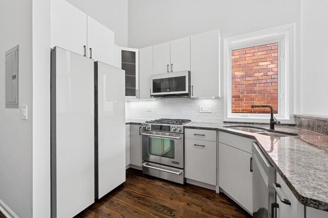 1018 N Honore Ave Unit C, Chicago, IL 60622 - kitchen featuring stainless steel appliances, a sink, electric panel, stone countertops, and white cabinetry