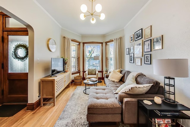 3746 N Hermitage Ave, Chicago, IL 60613 - living room featuring ornamental molding, light wood-type flooring, a chandelier, arched walkways, and baseboards