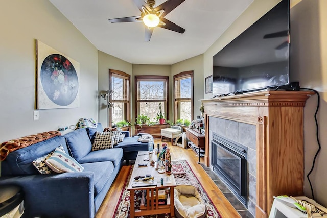 3746 N Hermitage Ave, Chicago, IL 60613 - living room with light wood-style flooring, a ceiling fan, and a tile fireplace
