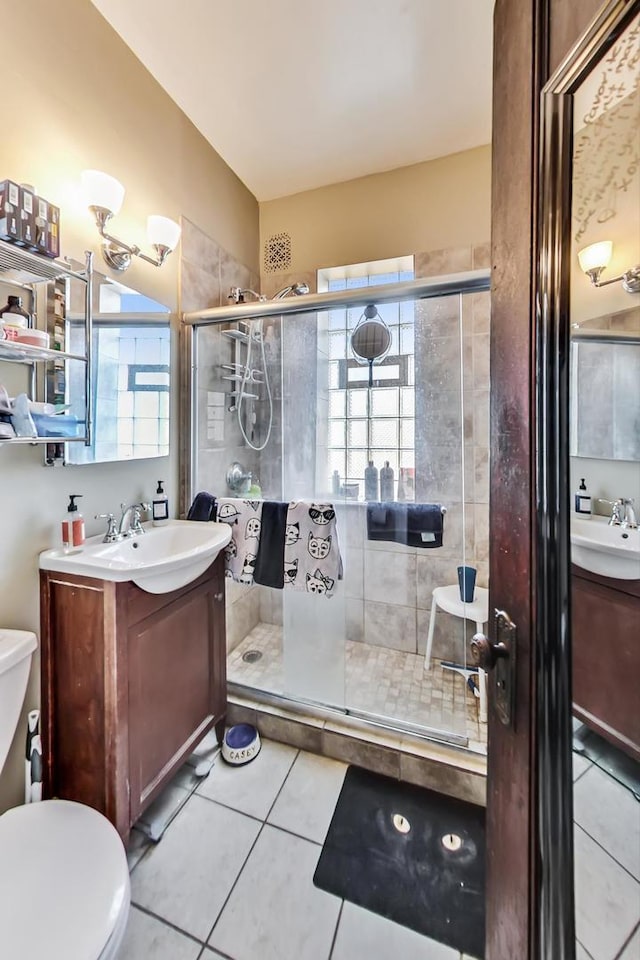 3746 N Hermitage Ave, Chicago, IL 60613 - bathroom with tile patterned floors, a shower stall, toilet, and vanity
