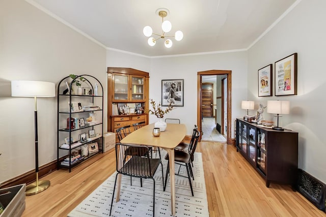 3746 N Hermitage Ave, Chicago, IL 60613 - dining room with a chandelier, light wood-style flooring, ornamental molding, and baseboards
