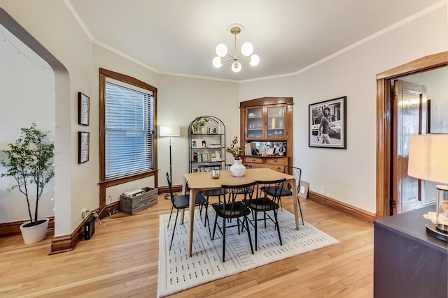 3746 N Hermitage Ave, Chicago, IL 60613 - dining space with light wood finished floors, crown molding, baseboards, and a chandelier