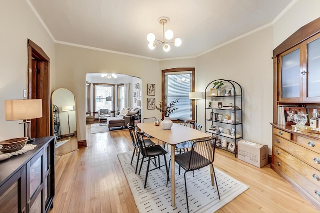 3746 N Hermitage Ave, Chicago, IL 60613 - dining space with arched walkways, a chandelier, light wood-style flooring, and ornamental molding