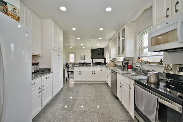 5025 Jerome Ave, Skokie, IL 60077 - kitchen featuring stainless steel appliances, healthy amount of natural light, white cabinets, recessed lighting, and a peninsula