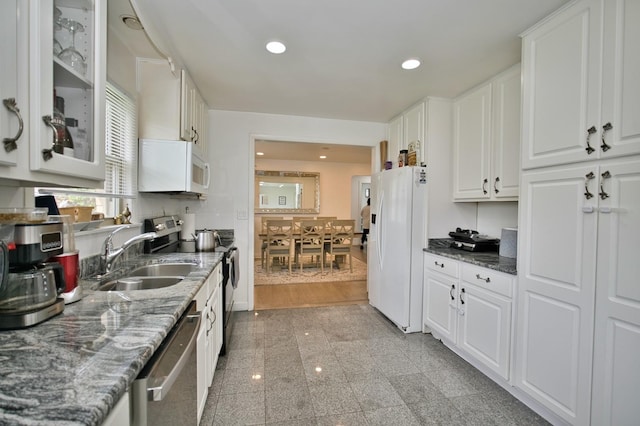 5025 Jerome Ave, Skokie, IL 60077 - kitchen with stainless steel appliances, a sink, white cabinets, granite floors, and glass insert cabinets