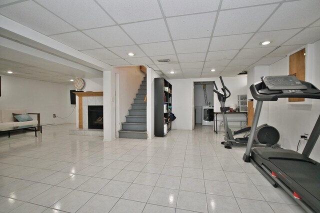 5025 Jerome Ave, Skokie, IL 60077 - workout room featuring washer / clothes dryer, a drop ceiling, light tile patterned floors, a fireplace, and recessed lighting