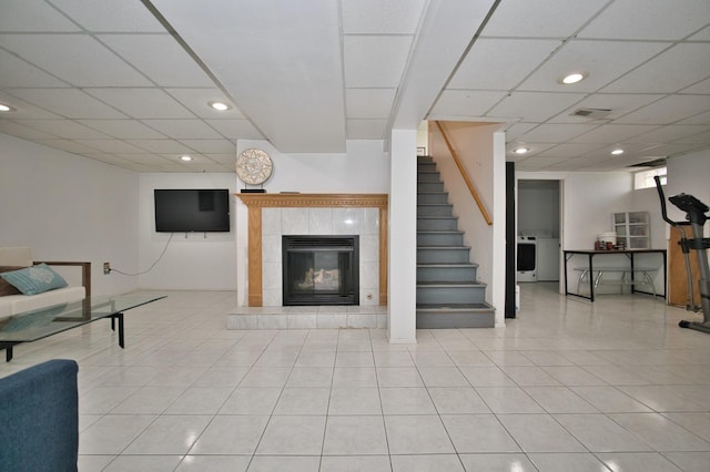 5025 Jerome Ave, Skokie, IL 60077 - tiled living area featuring washer / dryer, a fireplace, a drop ceiling, recessed lighting, and stairway