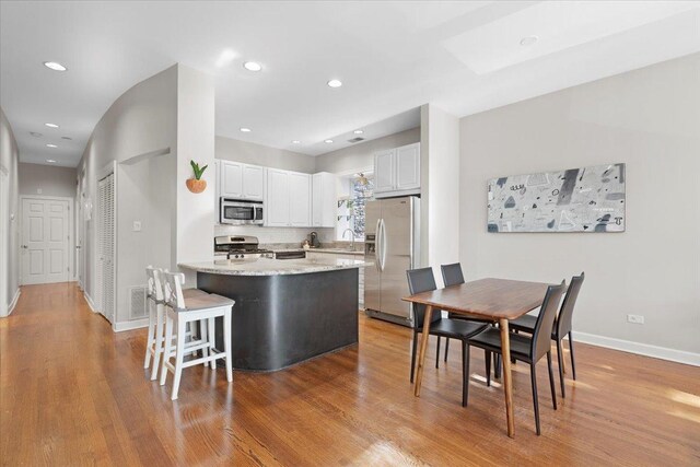 3616 N Janssen Ave Unit 2N, Chicago, IL 60613 - kitchen featuring appliances with stainless steel finishes, a sink, light wood-type flooring, white cabinets, and recessed lighting