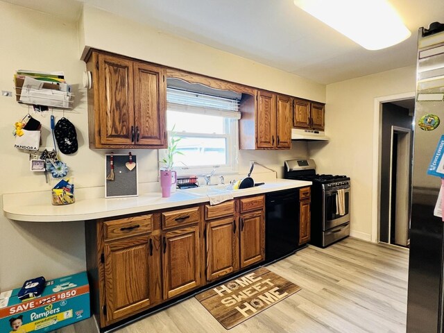 8605 Leclaire Ave, Burbank, IL 60459 - kitchen with gas range, black dishwasher, under cabinet range hood, light countertops, and light wood-style flooring