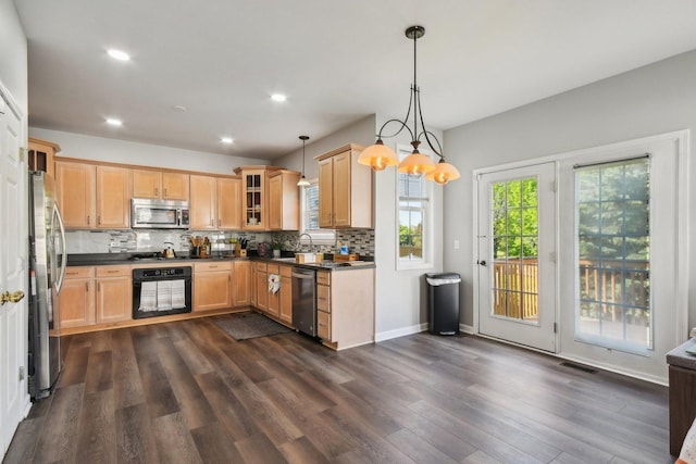 1159 Clover Hill Ln, Elgin, IL 60120 - kitchen featuring appliances with stainless steel finishes, dark countertops, decorative backsplash, glass insert cabinets, and dark wood-type flooring