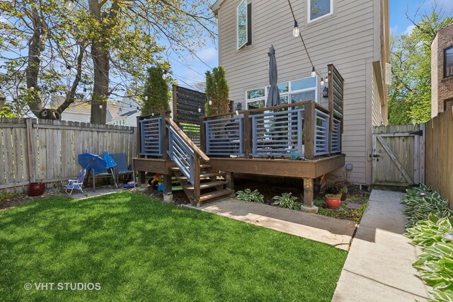 back of house with a gate and a wooden deck