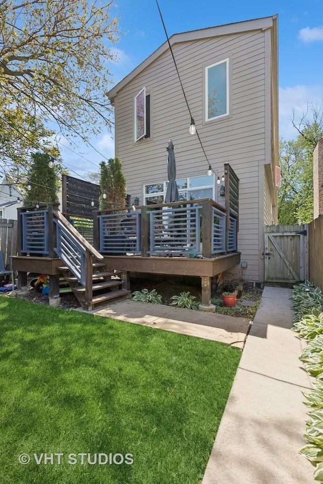 back of property featuring a gate and a deck