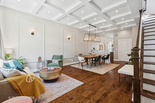 living area featuring stairway, coffered ceiling, dark wood-style floors, beamed ceiling, and recessed lighting