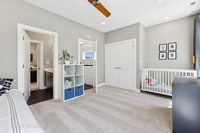carpeted bedroom featuring a closet, baseboards, a ceiling fan, recessed lighting, and ensuite bath