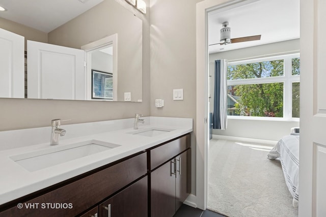 full bath with double vanity, baseboards, and a ceiling fan
