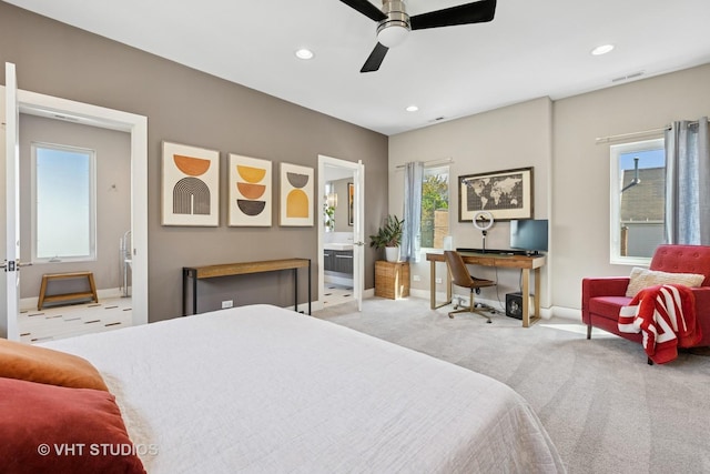 carpeted bedroom featuring an office area, baseboards, recessed lighting, ensuite bath, and a ceiling fan