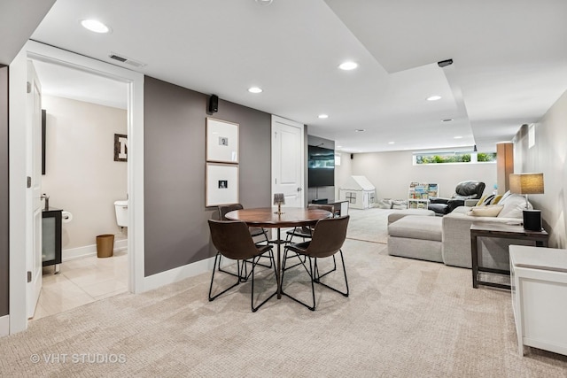 dining room featuring recessed lighting, baseboards, and light carpet