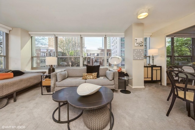 carpeted living room with plenty of natural light, expansive windows, and baseboards