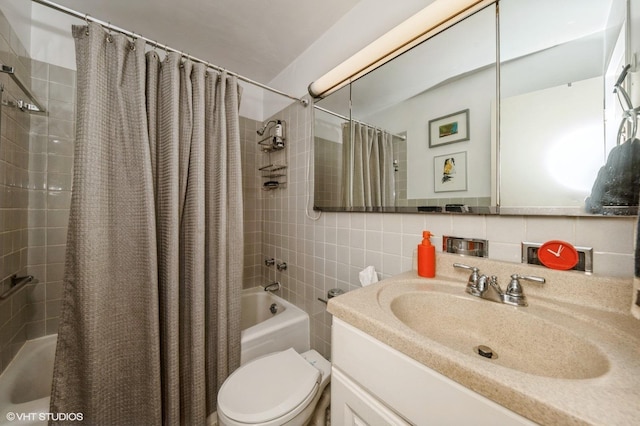 full bath with shower / bath combo with shower curtain, toilet, vanity, and tile walls