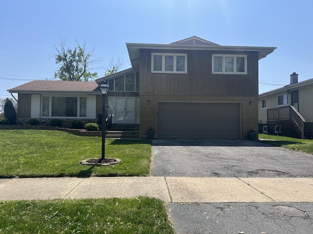 18840 May Ave, Homewood, IL 60430 - split level home with an attached garage, brick siding, asphalt driveway, and a front yard