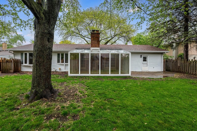937 Twilight Ln, Wheeling, IL 60090 - rear view of house with a sunroom, a chimney, a patio area, and roof with shingles