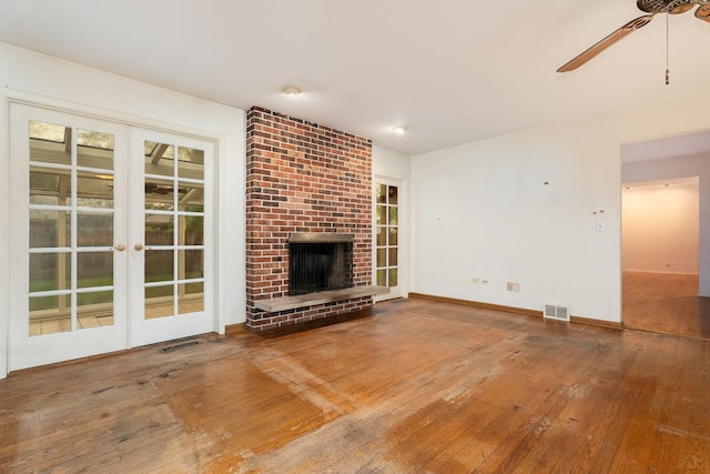 937 Twilight Ln, Wheeling, IL 60090 - unfurnished living room with ceiling fan, french doors, wood-type flooring, baseboards, and a fireplace