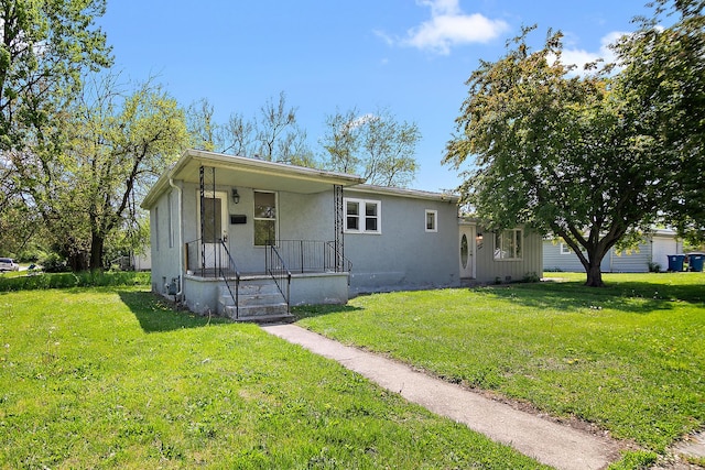 1990 Patrick Ave, Kankakee, IL 60901 - bungalow featuring a porch, stucco siding, and a front yard