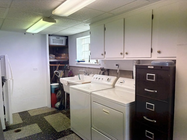 laundry room featuring cabinet space, separate washer and dryer, and dark floors