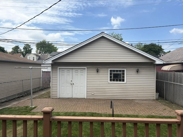 rear view of house featuring a fenced backyard and a patio
