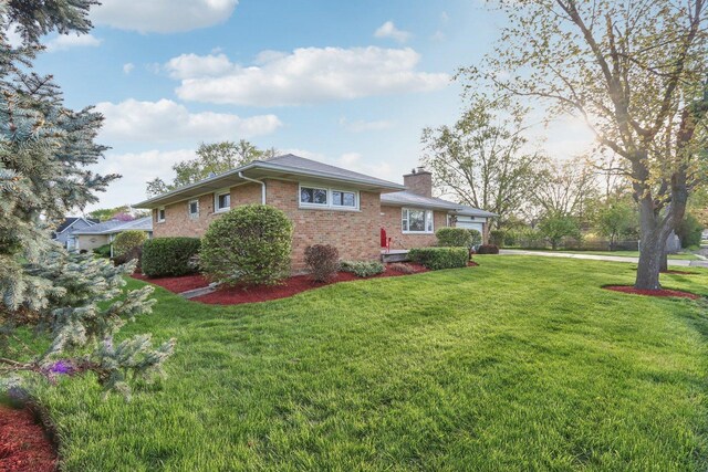 110 W Maude Ave, Arlington Heights, IL 60004 - view of home's exterior with brick siding, a chimney, a lawn, and an attached garage