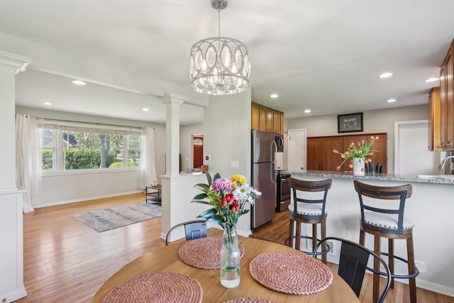 110 W Maude Ave, Arlington Heights, IL 60004 - dining space with decorative columns, light wood-style floors, recessed lighting, and baseboards