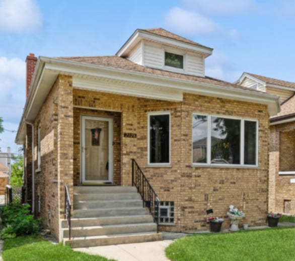 2128 N 75th Ave, Elmwood Park, IL 60707 - bungalow-style home with brick siding, a front yard, and a chimney