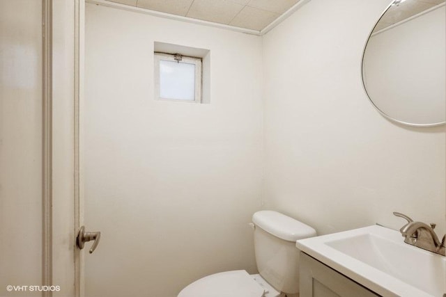 half bathroom featuring toilet and vanity