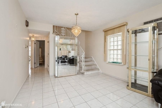 dining room featuring stairway, light tile patterned floors, baseboards, and a chandelier