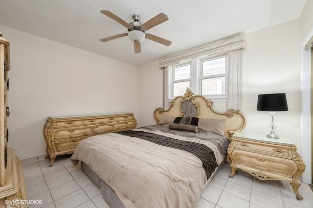 bedroom featuring light tile patterned floors, ceiling fan, and baseboards
