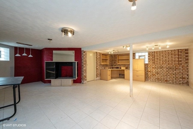 unfurnished living room with brick wall