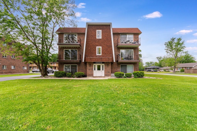 15302 Kenton Ave Unit 3, Oak Forest, IL 60452 - view of front of house featuring a balcony, brick siding, and a front yard