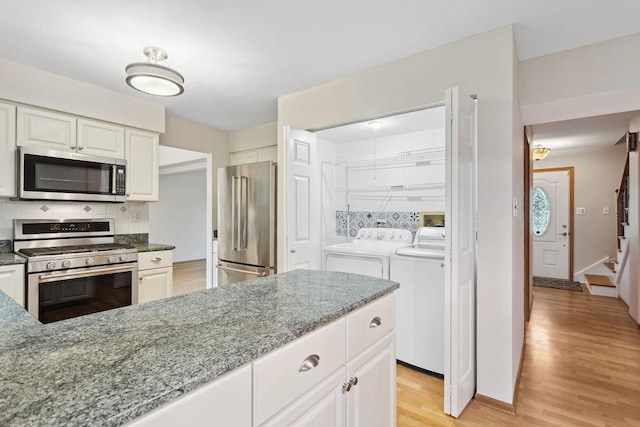 1836 71st St, Woodridge, IL 60517 - kitchen featuring stainless steel appliances, washer and clothes dryer, decorative backsplash, and stone countertops