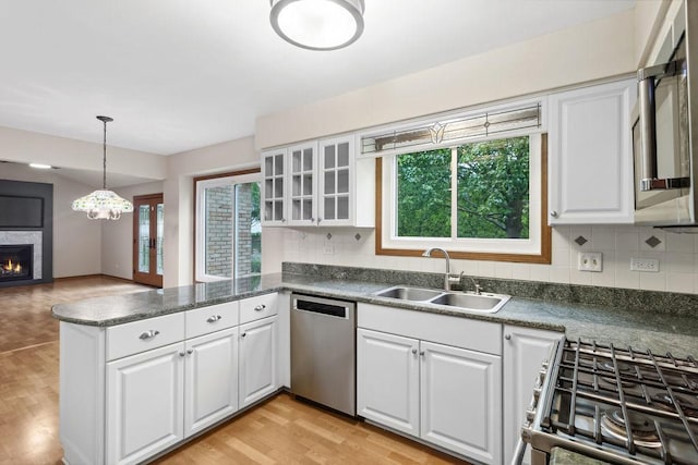 1836 71st St, Woodridge, IL 60517 - kitchen featuring appliances with stainless steel finishes, a sink, healthy amount of natural light, and white cabinetry