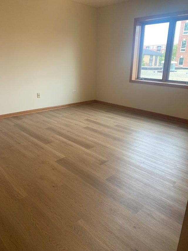 1327 E Washington St Unit 207, Des Plaines, IL 60016 - spare room with light wood-style flooring and baseboards