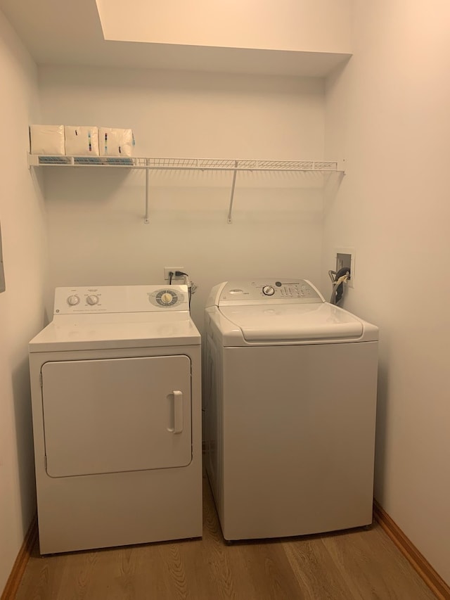 1327 E Washington St Unit 207, Des Plaines, IL 60016 - washroom featuring independent washer and dryer, wood finished floors, and baseboards