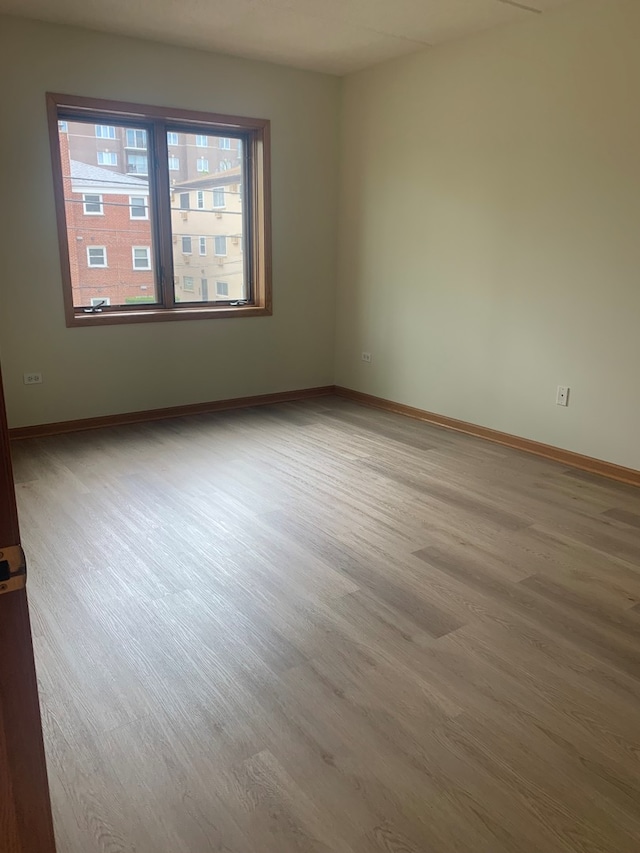1327 E Washington St Unit 207, Des Plaines, IL 60016 - unfurnished room with wood finished floors and baseboards