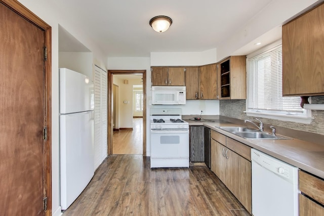 7657 N Osceola Ave, Niles, IL 60714 - kitchen with white appliances, dark wood-type flooring, brown cabinetry, and light countertops