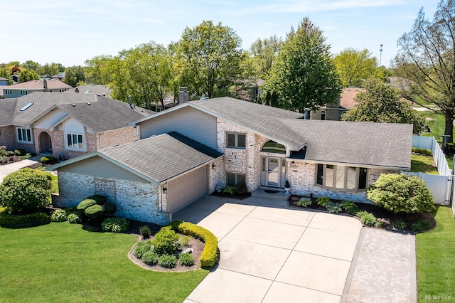 19634 Patricia Ln, Mokena, IL 60448 - view of front facade with brick siding, an attached garage, driveway, and a chimney