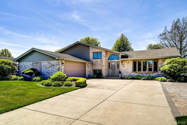 19634 Patricia Ln, Mokena, IL 60448 - split level home featuring brick siding, a front lawn, a garage, driveway, and a shingled roof