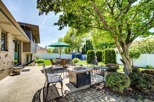 19634 Patricia Ln, Mokena, IL 60448 - view of patio / terrace with a fire pit, a fenced backyard, a shed, and an outdoor structure