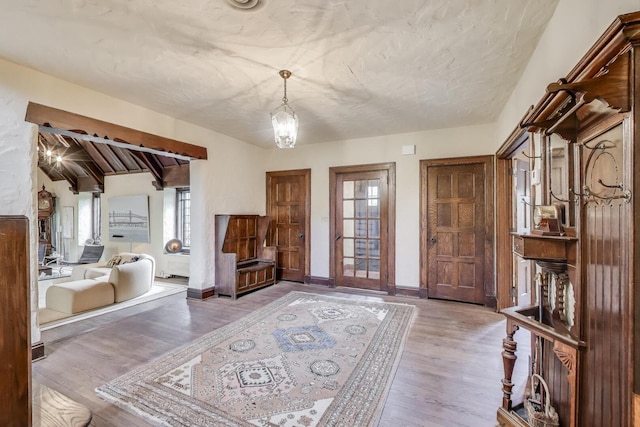 entryway featuring wood finished floors and baseboards